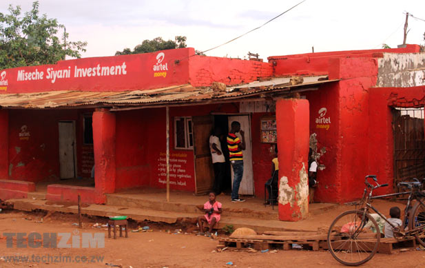 The makeshift movie house at a Likuni shopping center, Lilongwe, Malawi. The guys there are looking at movie posters. Yes, that's airtel money there. I should have asked if they are a mobile money agent or just a billboard!